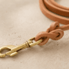 Close-up of a genuine leather dog leash knot with brass clip hardware
