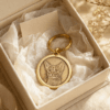 Custom engraved brass pet tag with a cat portrait presented in a premium gift box with tissue paper and warm neutral styling