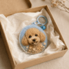 Custom dog portrait felt charm presented in a kraft gift box with tissue paper, handmade wool felt texture, floral embroidery, and blue keyring