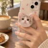Personalized pet phone grip being used naturally while holding a smartphone.