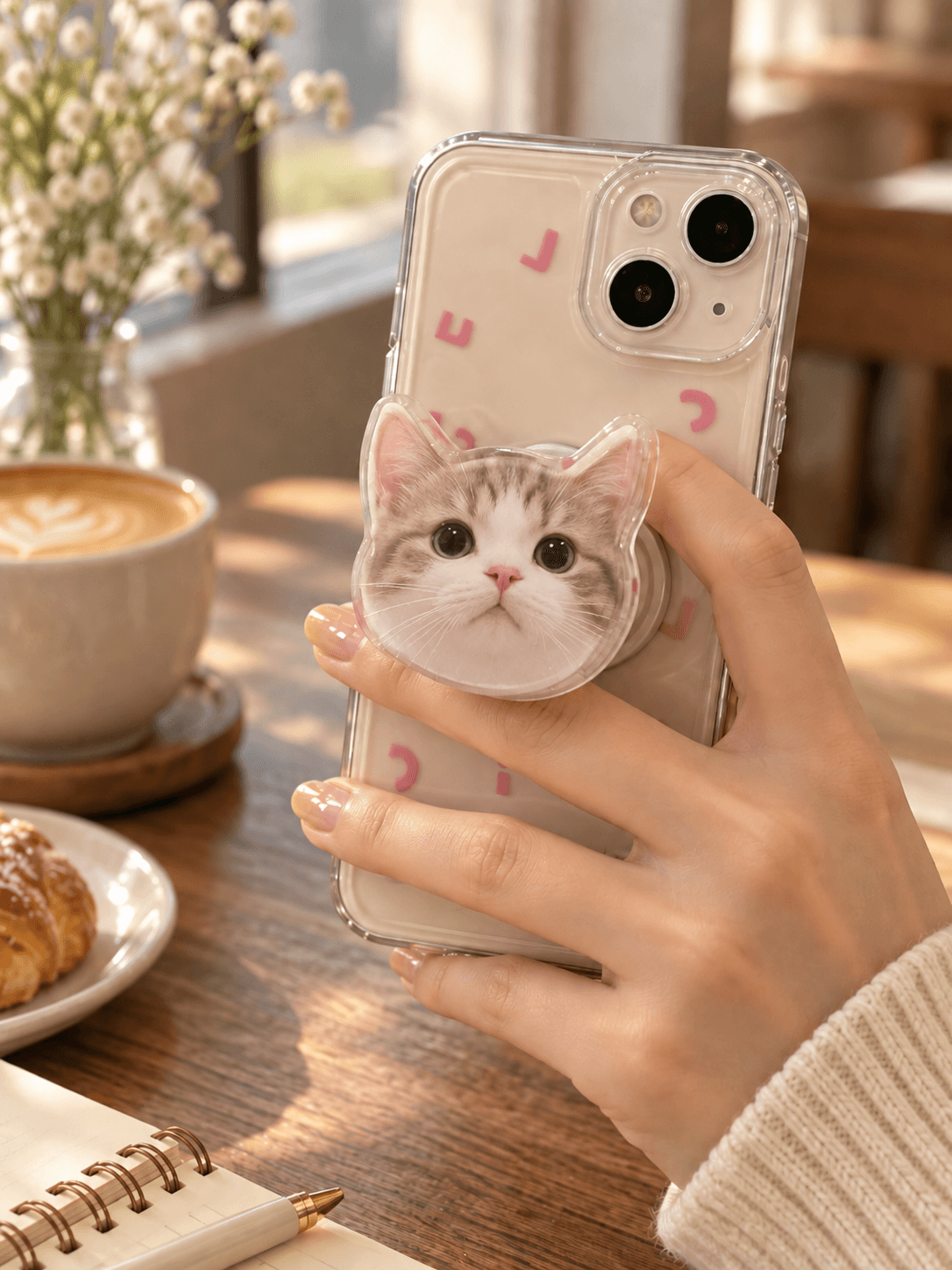 Personalized pet phone grip being used naturally while holding a smartphone.